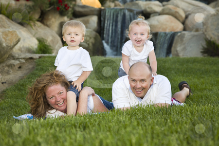 To use this stock image in your creative project, please select the size you need over to the right and click the "Add to Cart" button.
Your downloaded image will come with the Cutcaster watermark removed so don’t worry about the watermark you see on this page. Happy Young Family with Twins Portrait in Park stock photo, Happy Young Adorable Family with Twins Portrait on Grass in the Park. by Andy Dean