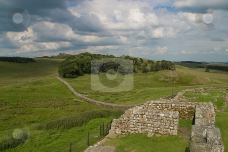 To use this stock image in your creative project, please select the size you need over to the right and click the "Add to Cart" button.
Your downloaded image will come with the Cutcaster watermark removed so don’t worry about the watermark you see on this page. Hadrain's Wall stock photo, The remains of a fortress along Hadrain's Wall on the England/Scotland border. by SidWebb