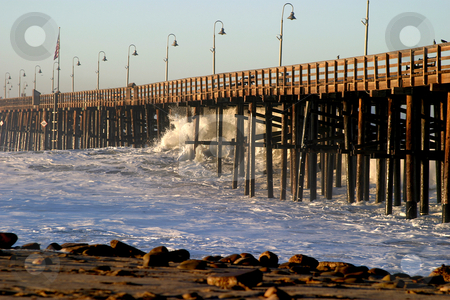 To use this stock image in your creative project, please select the size you need over to the right and click the "Add to Cart" button.
Your downloaded image will come with the Cutcaster watermark removed so don’t worry about the watermark you see on this page. Ocean Wave Storm Pier stock photo, Ocean waves throughout at storm crashing into a wooden pier. by Henrik Lehnerer