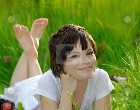 To use this stock image in your creative project, please select the size you need over to the right and click the "Add to Cart" button.
Your downloaded image will come with the Cutcaster watermark removed so don’t worry about the watermark you see on this page. Natural beauty stock photo, caucasian girl in white summer dress relaxing outdoors on a breezy day in sunshine on green grass field. (motion of grass due to wind blowing)
by JOSEPH S.L. TAN MATT