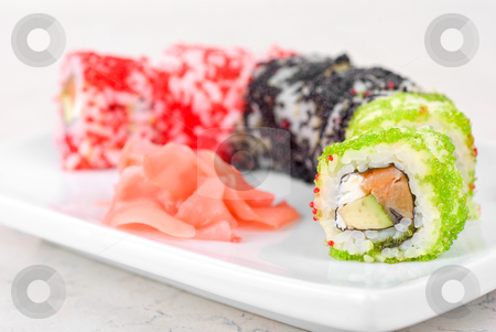 To use this stock image in your creative project, please select the size you need over to the right and click the "Add to Cart" button.
Your downloaded image will come with the Cutcaster watermark removed so don’t worry about the watermark you see on this page. Sushi rolls stock photo, Sushi rolls made of fish avocado and different flying fish roe (tobiko caviar) by olinchuk