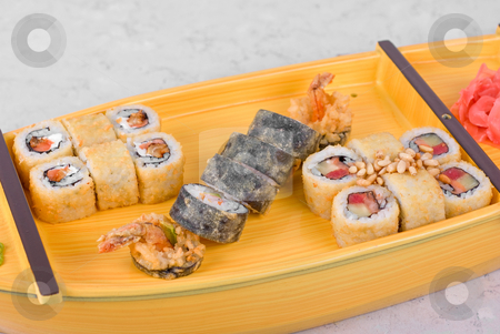 To use this stock image in your creative project, please select the size you need over to the right and click the "Add to Cart" button.
Your downloaded image will come with the Cutcaster watermark removed so don’t worry about the watermark you see on this page. Sushi ship stock photo, japanese food of wooden ship with various type of sushi by olinchuk