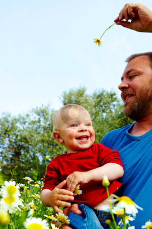 To use this stock image in your creative project, please select the size you need over to the right and click the "Add to Cart" button.
Your downloaded image will come with the Cutcaster watermark removed so don’t worry about the watermark you see on this page. Father and son in flowers stock photo, little boy and his father enjoying outdoors in field of flowers on a summer day by lubavnel