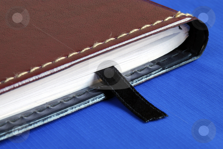 To use this stock image in your creative project, please select the size you need over to the right and click the "Add to Cart" button.
Your downloaded image will come with the Cutcaster watermark removed so don’t worry about the watermark you see on this page. Brown notebook with a black bookmark isolated on blue stock photo, Brown notebook with a black bookmark isolated on blue by johnkwan