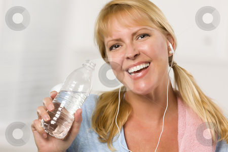 To use this stock image in your creative project, please select the size you need over to the right and click the "Add to Cart" button.
Your downloaded image will come with the Cutcaster watermark removed so don’t worry about the watermark you see on this page. Pretty Blonde Woman with Towel Drinking From Water Bottle stock photo, Pretty Blonde Woman with Towel and Ear Phones Drinking From Water Bottle in Her Kitchen. by Andy Dean