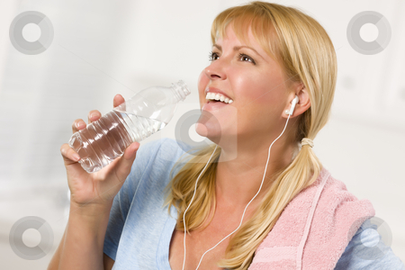 To use this stock image in your creative project, please select the size you need over to the right and click the "Add to Cart" button.
Your downloaded image will come with the Cutcaster watermark removed so don’t worry about the watermark you see on this page. Pretty Blonde Woman with Towel Drinking From Water Bottle stock photo, Pretty Blonde Woman with Towel and Ear Phones Drinking From Water Bottle in Her Kitchen. by Andy Dean