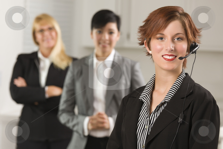 To use this stock image in your creative project, please select the size you need over to the right and click the "Add to Cart" button.
Your downloaded image will come with the Cutcaster watermark removed so don’t worry about the watermark you see on this page. Pretty Red Haired Businesswoman with Headset and Colleagues stock photo, Pretty Red Haired Businesswoman with Headset and Colleagues Behind in Office Setting. by Andy Dean