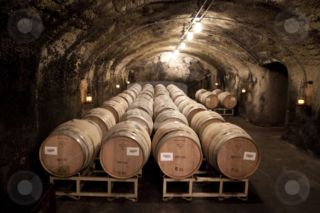 To use this stock image in your creative project, please select the size you need over to the right and click the "Add to Cart" button.
Your downloaded image will come with the Cutcaster watermark removed so don’t worry about the watermark you see on this page. Cave Cellar stock photo, Barrels of wine located in a cave cellar by Kevin Tietz